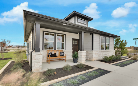 A house with a bench in the front.