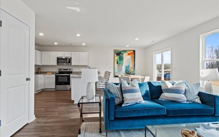 A living room with a blue couch.