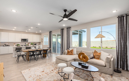 A living room with a large chandelier and a large window.