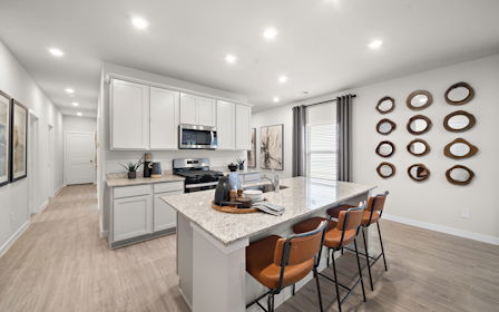 A kitchen with a dining table and chairs.