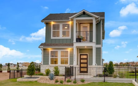 A house with a fence around it with Apsley House in the background.