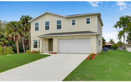 A house with a garage and trees.