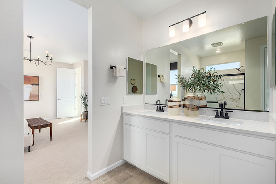 A bathroom with a large mirror.