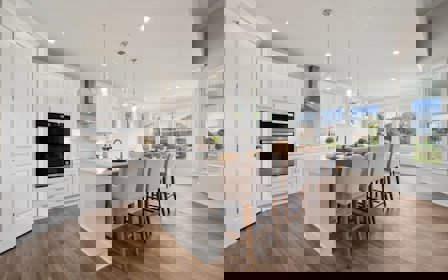 A kitchen with a dining table and chairs.