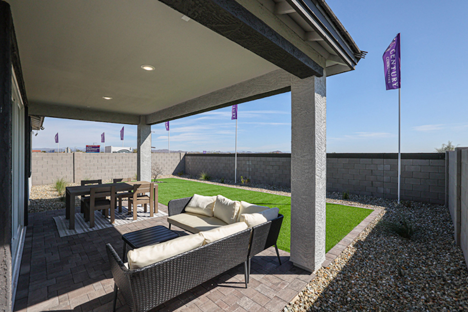 A patio with a patio and a table and chairs and a large window.