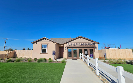 A building with a white fence.