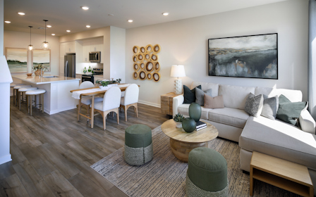 A living room with a large dining table and couches.