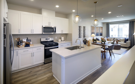 A kitchen with white cabinets.
