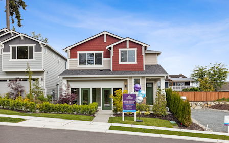 A house with a sign in front.