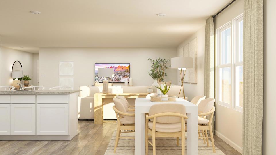 A kitchen with a dining table and chairs.