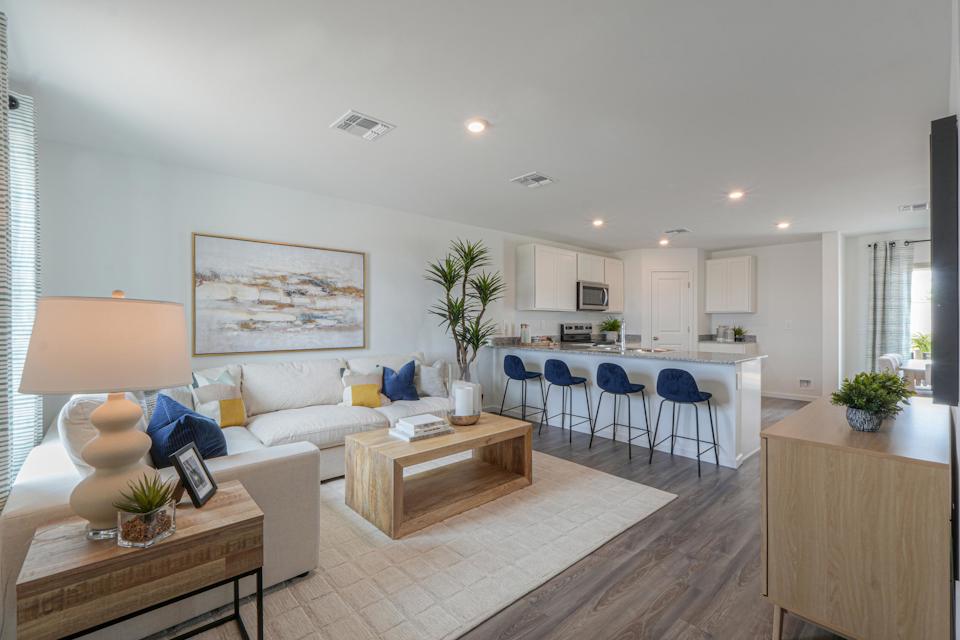 A living room with a couch and chairs.
