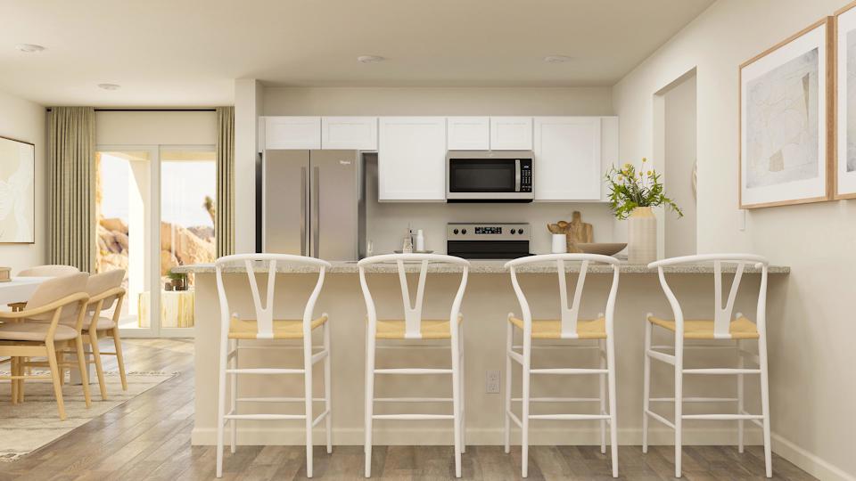 A kitchen with a dining table and chairs.