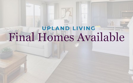 A room with white couches and a table.