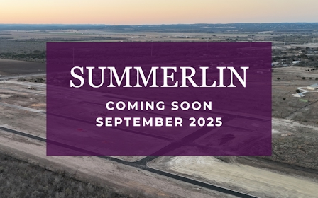 A large flat area with a body of water in the background.